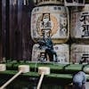 Kyoto's Shinto shrine with ceremonial water ladles and sake barrels reflecting Japanese culture.